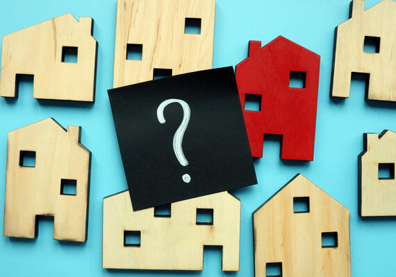 Image with wooden houses and question mark