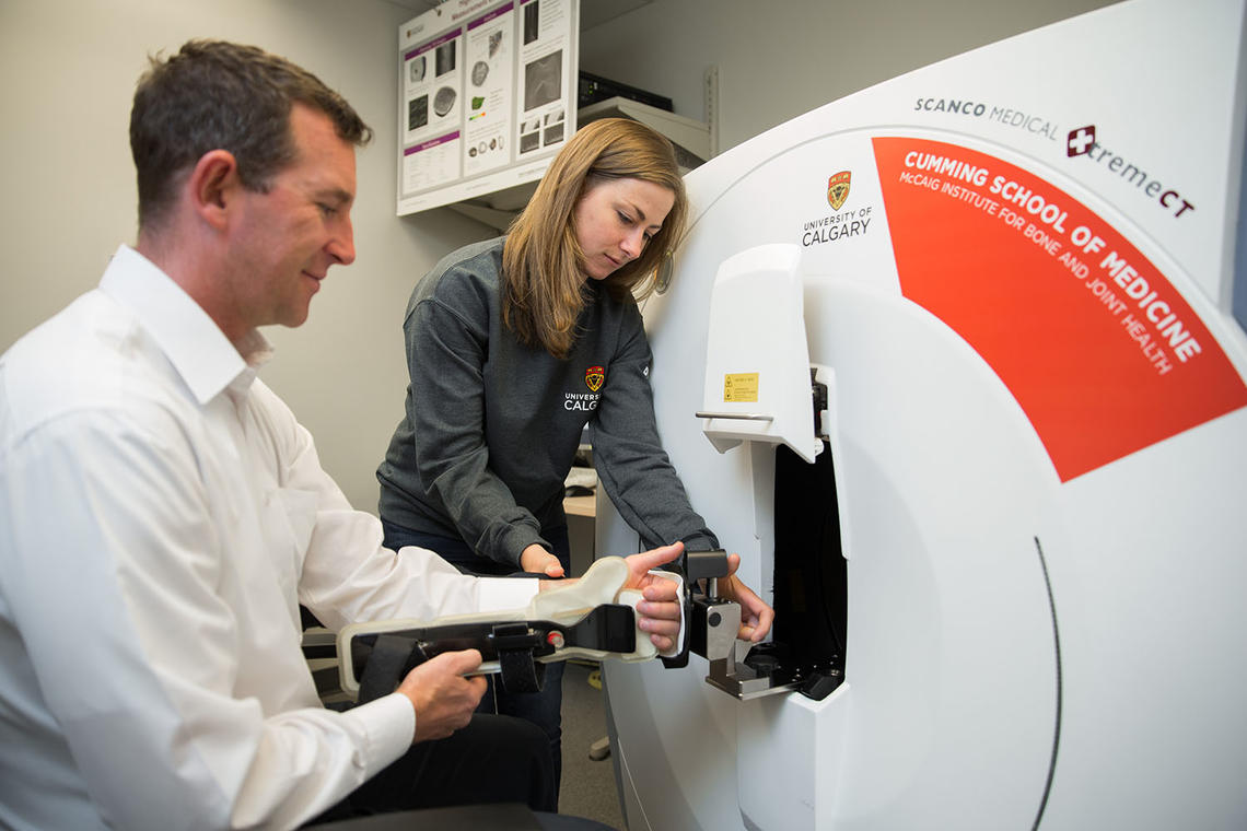 James Tommasson, participant in the study A Biomedical Engineering Approach to Investigating Bone Quality Across the Lifespan, has his wrist scanned by Danielle Whittier, grad student in Steven Boyd's Bone Imaging Lab.