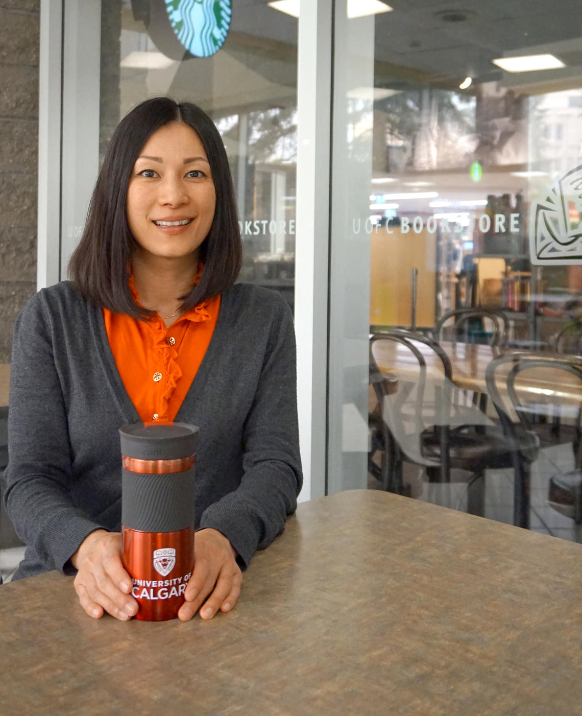 Photo of Gina Ko holding an ecofriendly mug