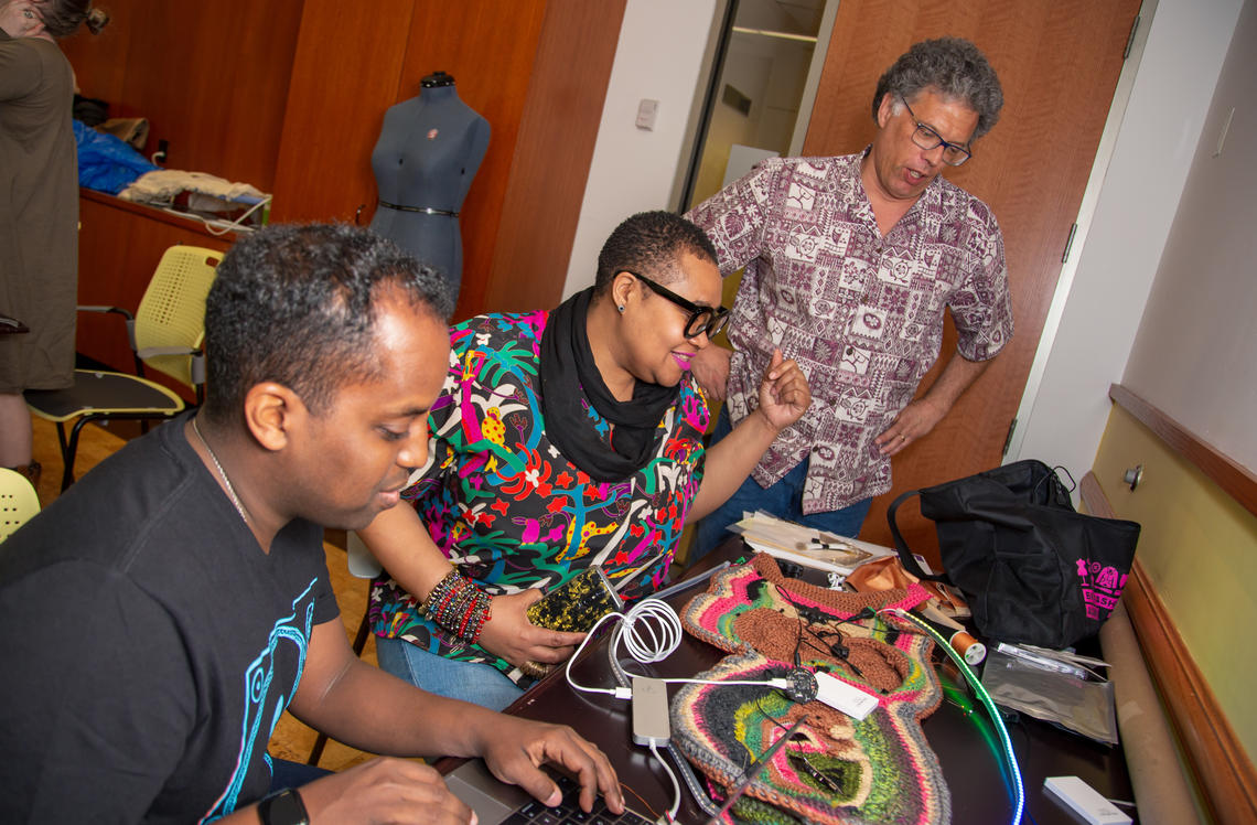 Grad student Teddy Seyed, left, strategizing the construction of a garment that uses multiple smart tattoos, accelerometers, lights and other components.