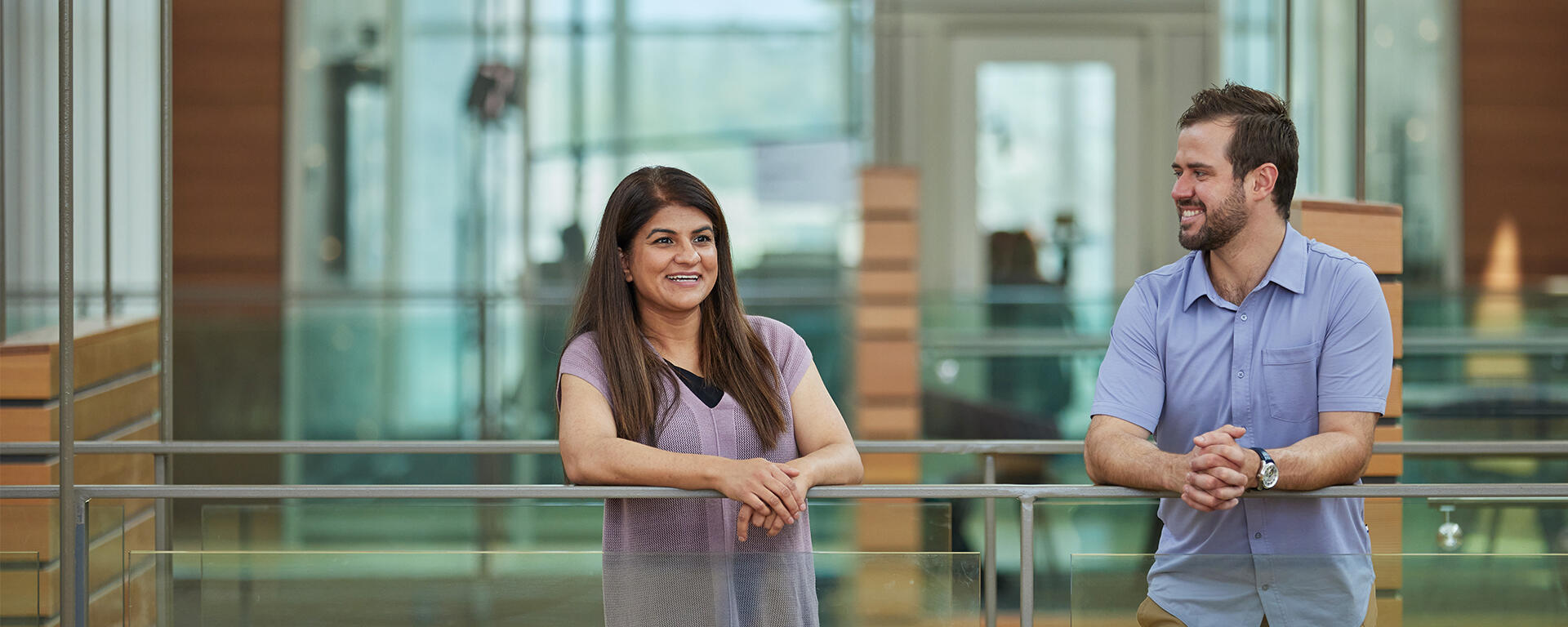 MBA students chatting on a glass bridge