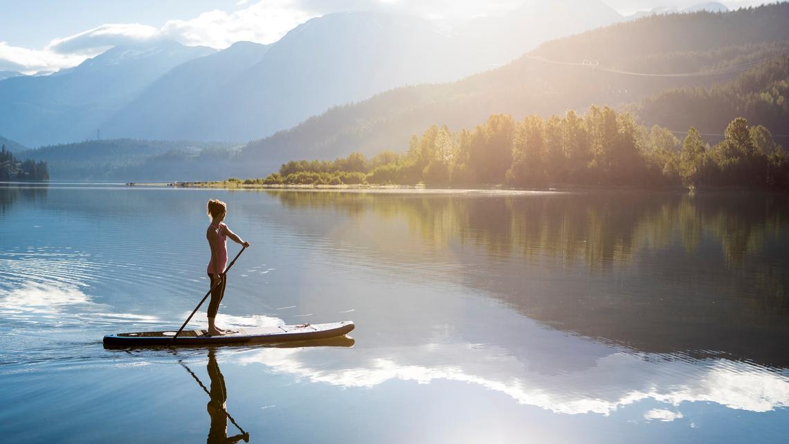 Stand up paddle boarder on the lake in Whistler