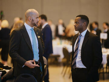 Chancellor Jon Cornish talking with a guest