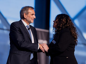 Carlos Pascual shaking hands with Dean Gina Grandy of Haskayne School of Business