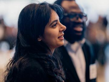 2025 PETRONAS guests listening and smiling