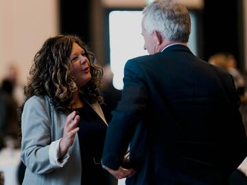 Dean Gina Grandy chatting with a guest