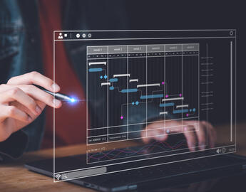 An artifical screen with a hand holding a pen showing a digital flow chart of building code with AI. 